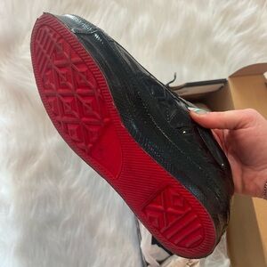 Black patent red-bottom converse sneakers